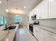 The kitchen features stainless steel appliances, lots of counter space, and white cabinets at 13349 Niti Dr, Hudson, FL 34669