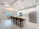 Kitchen featuring a center island with a stainless refrigerator, a breakfast bar, and white cabinets at 13349 Niti Dr, Hudson, FL 34669