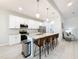 Modern kitchen featuring stainless appliances, white cabinets, and an island with bar stool seating at 13349 Niti Dr, Hudson, FL 34669