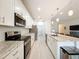 Bright kitchen features stainless appliances, stone countertops, and ample cabinet space at 13349 Niti Dr, Hudson, FL 34669