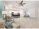 Open concept living area with hardwood floors and a ceiling fan at 13349 Niti Dr, Hudson, FL 34669