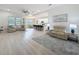 Bright living room with hard wood floors and open to the dining and kitchen area at 13349 Niti Dr, Hudson, FL 34669