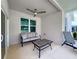 Outdoor patio space with neutral sofa, coffee table, ceiling fan, and lounge chair at 13349 Niti Dr, Hudson, FL 34669