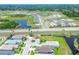 An aerial view of a residential neighborhood with a pond in the distance at 14011 Shoal Dr, Hudson, FL 34667