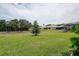 Expansive backyard featuring lush green grass and views of the surrounding trees, with a home in the background at 14011 Shoal Dr, Hudson, FL 34667