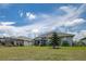 Spacious backyard with lush lawn and landscaping, adjacent to two screened in lanais at 14011 Shoal Dr, Hudson, FL 34667