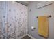Cozy bathroom featuring a floral shower curtain and updated towel rack at 14011 Shoal Dr, Hudson, FL 34667