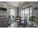 Charming dining area with a wooden table, striped chairs, decorative accents, and view to backyard at 14011 Shoal Dr, Hudson, FL 34667