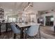 Dining area with modern table and chairs, open to the kitchen and living area, creating an airy and social space at 14011 Shoal Dr, Hudson, FL 34667