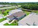 Beautiful single-Gathering home with a two-car garage, walkway, and well-maintained lawn near a pond at 14011 Shoal Dr, Hudson, FL 34667