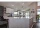 Modern kitchen featuring white cabinetry, quartz countertops, and stylish backsplash, creating an elegant cooking space at 14011 Shoal Dr, Hudson, FL 34667