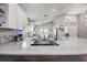 Bright kitchen features white cabinets, stainless steel appliances, and modern finishes with an open floorplan at 14011 Shoal Dr, Hudson, FL 34667