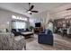 Bright living room featuring hardwood floors, a ceiling fan, and stylish furnishings, creating a comfortable and relaxing space at 14011 Shoal Dr, Hudson, FL 34667