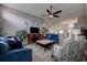 Spacious living room featuring stylish furnishings and a ceiling fan with an open view into the kitchen at 14011 Shoal Dr, Hudson, FL 34667