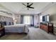 Spacious main bedroom with a tray ceiling, a ceiling fan, and soft, natural light at 14011 Shoal Dr, Hudson, FL 34667