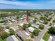 An aerial shot reveals a cozy home in a quiet neighborhood, enhanced by mature trees and landscaping at 16037 Brookridge Blvd, Brooksville, FL 34613