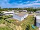 Aerial view of a home in a neighborhood, showcasing its layout, landscaping, and surrounding properties at 16037 Brookridge Blvd, Brooksville, FL 34613