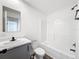 Bright bathroom featuring modern fixtures, vanity, toilet, and tiled shower/bathtub combo at 16037 Brookridge Blvd, Brooksville, FL 34613