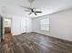 Bedroom featuring wood-look floors, a ceiling fan, ensuite bathroom, and closet at 16037 Brookridge Blvd, Brooksville, FL 34613