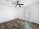 This bedroom boasts wood-look floors, a ceiling fan, and closet at 16037 Brookridge Blvd, Brooksville, FL 34613