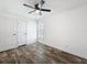 Minimalist bedroom design with neutral walls, a ceiling fan, and wood-style flooring at 16037 Brookridge Blvd, Brooksville, FL 34613