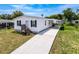 Charming single-story home featuring a covered carport and a well-maintained lawn at 16037 Brookridge Blvd, Brooksville, FL 34613
