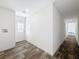 Hallway featuring wood-look floors, neutral paint, and natural light at 16037 Brookridge Blvd, Brooksville, FL 34613