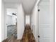 Hallway view showcasing neutral color palette and wood-look flooring throughout at 16037 Brookridge Blvd, Brooksville, FL 34613