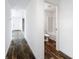 Hallway leading to bathroom with view of tiled shower/bathtub and modern fixtures at 16037 Brookridge Blvd, Brooksville, FL 34613