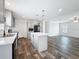 Modern kitchen featuring gray cabinets, island with marble countertops, and open layout to living area at 16037 Brookridge Blvd, Brooksville, FL 34613