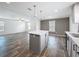 Open kitchen and living area with large island, modern countertops, and gray cabinets at 16037 Brookridge Blvd, Brooksville, FL 34613