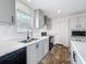 Bright kitchen showcasing gray cabinets, stainless steel sink, and updated appliances at 16037 Brookridge Blvd, Brooksville, FL 34613