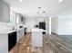 Modern kitchen featuring grey cabinets, a center island, and stainless steel appliances at 16037 Brookridge Blvd, Brooksville, FL 34613