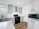 Well-lit kitchen featuring gray cabinets, modern appliances, and stylish countertops at 16037 Brookridge Blvd, Brooksville, FL 34613