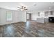 Inviting living room featuring wood flooring and a seamless transition to the modern kitchen at 16037 Brookridge Blvd, Brooksville, FL 34613