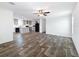 Open living room showcasing wood flooring and a seamless transition to the modern kitchen at 16037 Brookridge Blvd, Brooksville, FL 34613