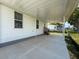 Covered patio with stairs providing access to the house, surrounded by well-maintained landscaping at 16037 Brookridge Blvd, Brooksville, FL 34613