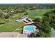 Aerial view of a community pool, lush landscaping, golf course, and putting greens at 2139 Sea Pines Ct, Spring Hill, FL 34606