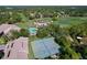 Aerial view of community amenities including pool, tennis courts, golf course, and mature trees at 2139 Sea Pines Ct, Spring Hill, FL 34606