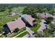 Aerial shot of a community clubhouse, pool, golf course, and parking area at 2139 Sea Pines Ct, Spring Hill, FL 34606
