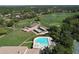 Overhead view of a meticulously designed golf course adjacent to a sparkling community pool at 2139 Sea Pines Ct, Spring Hill, FL 34606