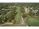 Aerial view of a well-maintained golf course surrounded by lush trees and residential homes at 2139 Sea Pines Ct, Spring Hill, FL 34606