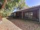 View of the home's backyard with a screened-in patio, mature trees, and outdoor space at 2139 Sea Pines Ct, Spring Hill, FL 34606