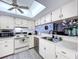Bright kitchen with white appliances, light wood floors and light fixtures, and ample counter space at 2139 Sea Pines Ct, Spring Hill, FL 34606