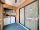 This laundry room features a washer and dryer, storage shelves, and access to the sunroom at 2139 Sea Pines Ct, Spring Hill, FL 34606