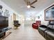 Open-concept living room with wood-look flooring and updated fixtures at 2139 Sea Pines Ct, Spring Hill, FL 34606