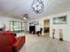 Open-concept living area with sliding glass doors, modern flooring, and stylish decor at 2139 Sea Pines Ct, Spring Hill, FL 34606