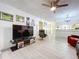 Spacious living room with modern flooring, a ceiling fan, and ample natural light at 2139 Sea Pines Ct, Spring Hill, FL 34606