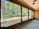 View from the screened patio to the backyard with mature trees and outdoor space at 2139 Sea Pines Ct, Spring Hill, FL 34606