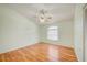 This room has hardwood flooring, a ceiling fan, and a window at 2348 Rolling View Dr, Spring Hill, FL 34606
